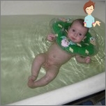 Swimming baby in a large bath