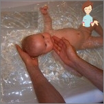 Swimming baby in a large bath